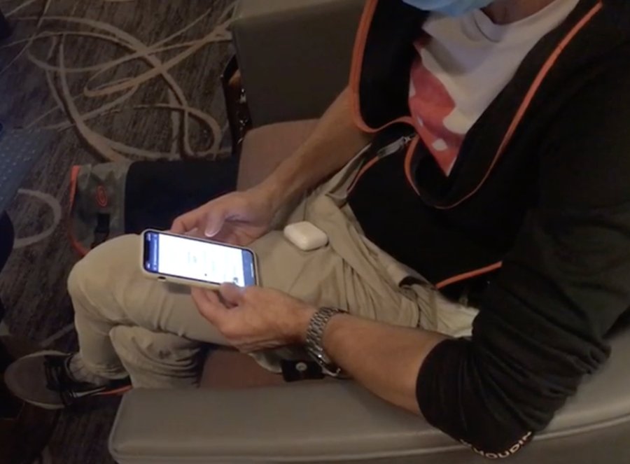 A participant using the prototype on a mobile phone during a moderated testing session